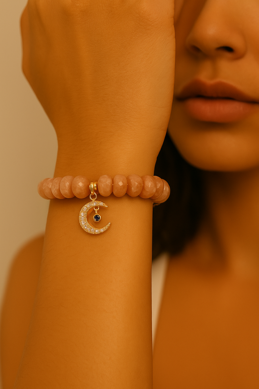 Woman wearing beaded bracelet with crescent moon and gemstone charm close-up