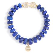 Faceted blue gemstone beaded bracelet with gold clasp and round gold charm